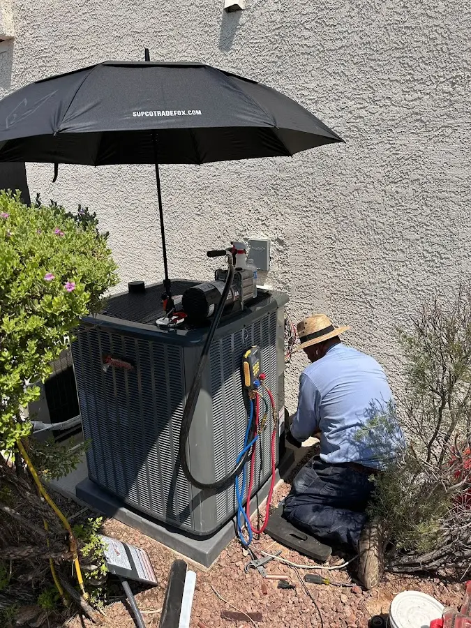 HVAC technician performing outdoor AC maintenance in Wahoo